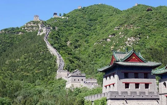 Fortified gate tower at Juyongguan, with the Great Wall climbing the green hillside behind it
