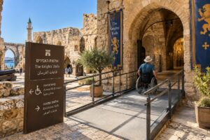 Wheelchair user entering the Knights’ Halls in Akko via an accessible ramp