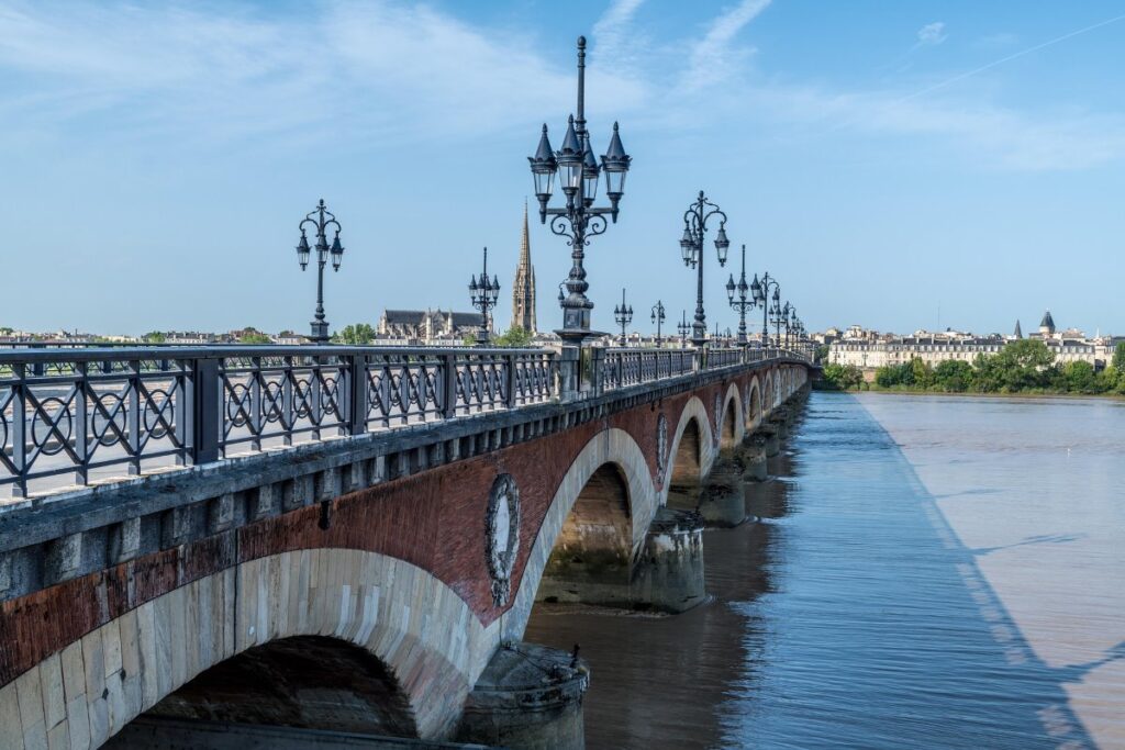 Historic stone bridge over the Garonne River in Bordeaux, France