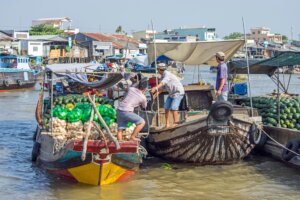 Boats trading produce at a floating market in the Mekong Delta, Vietnam