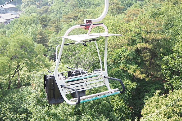Empty open chairlift above the forest at Mutianyu Great Wall
