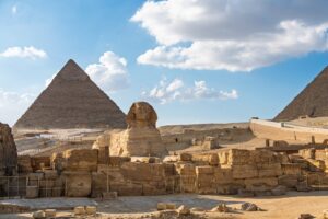 The Great Sphinx with two of the Pyramids of Giza in the background