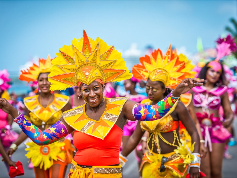 Junkanoo performers in colourful costumes and elaborate yellow headdresses in the Bahamas