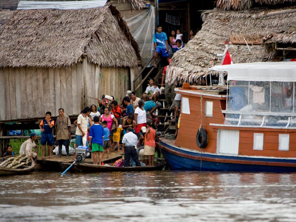 Riverside community along the Amazon River with local boats and wooden houses