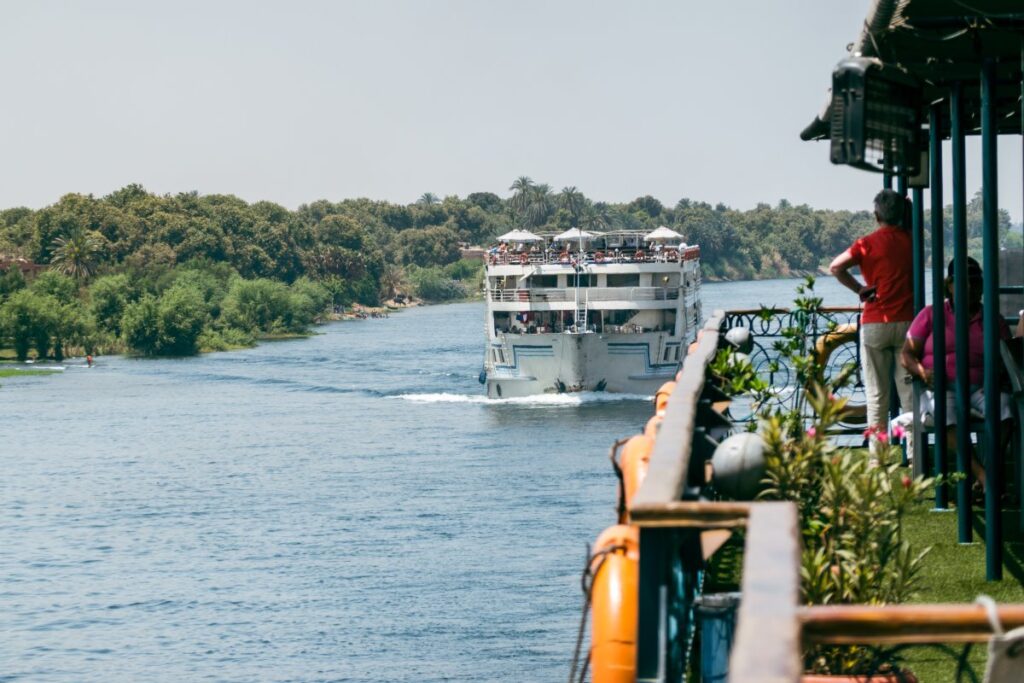 Nile River cruise boats sailing between Luxor and Aswan in Egypt
