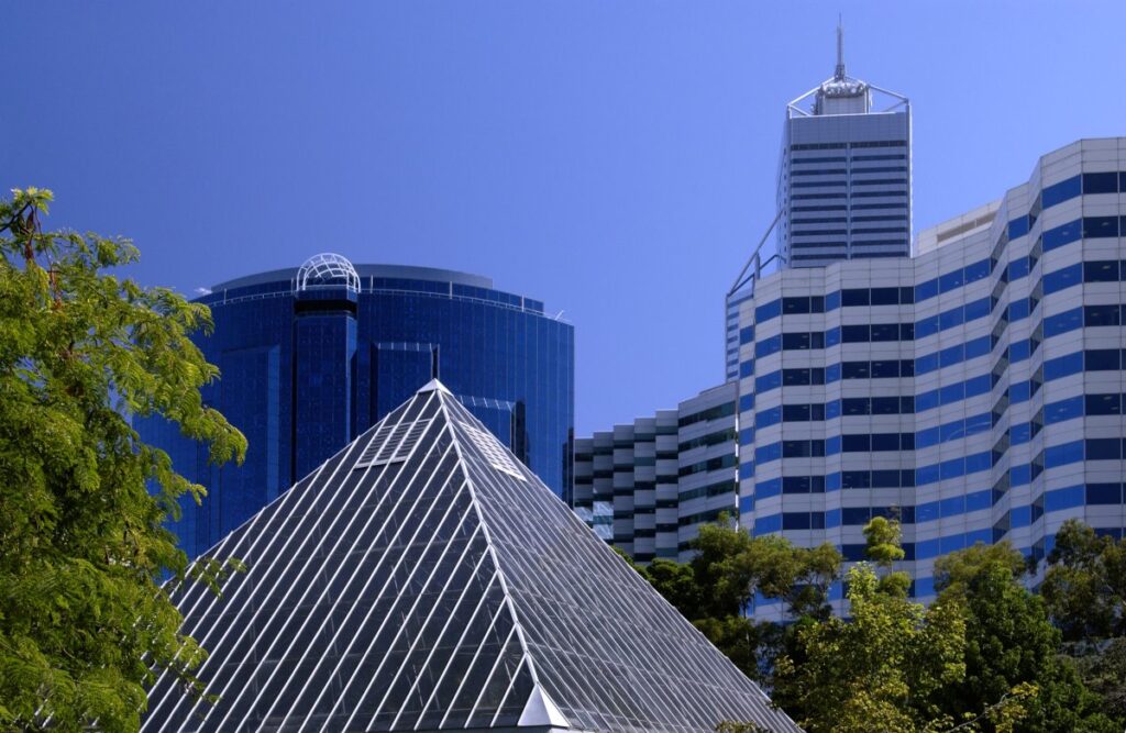 Glass pyramid surrounded by trees and modern buildings in Perth, Western Australia