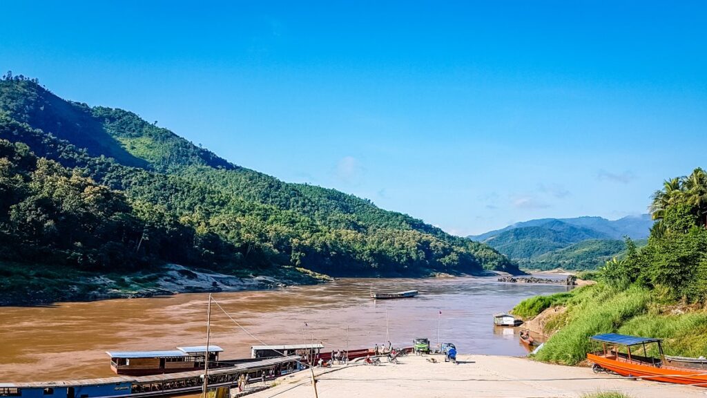 Mekong River during the dry season with low water levels and boats along the riverbank
