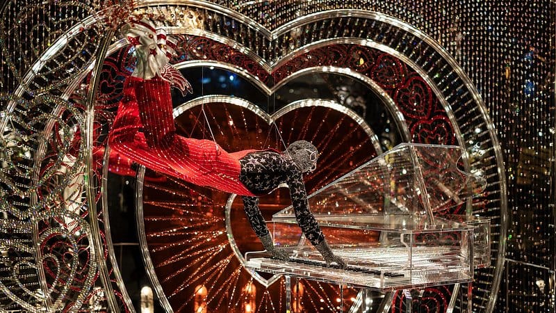 Crystal-covered figure playing a transparent piano inside Swarovski Crystal Worlds in Wattens