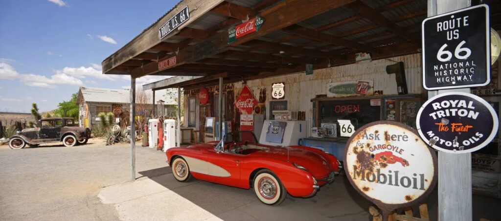 Historic Route 66 sign with vintage roadside gas station signs
