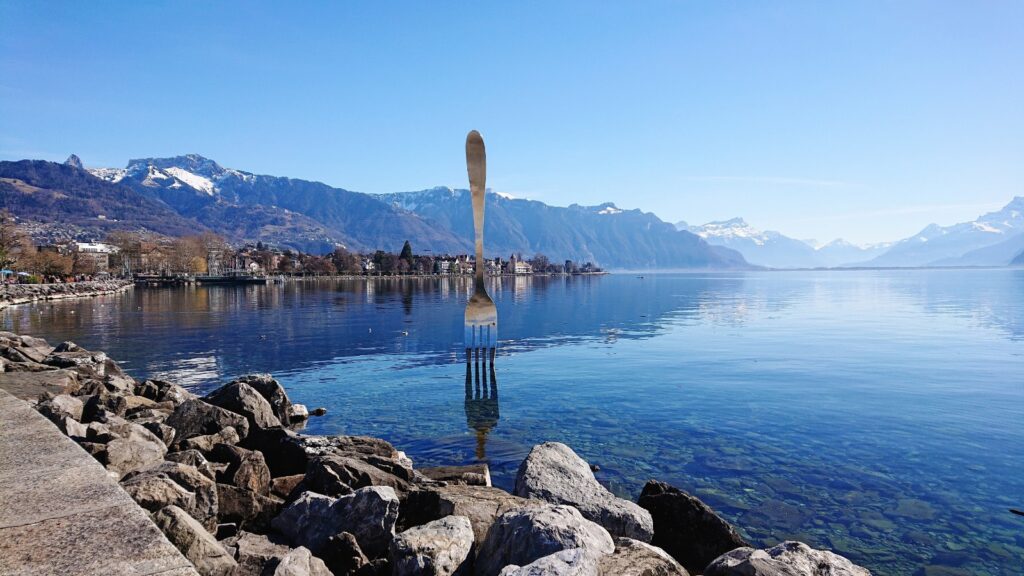 Fork of Vevey standing in Lake Geneva with the Swiss Alps in the background