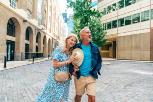 Couple walking together along a quiet cobblestone street while travelling slower after 50