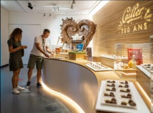 Visitor tasting chocolate at Maison Cailler in Broc, Switzerland