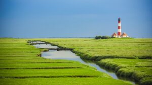 Wadden Sea salt marshes with lighthouse and tidal channel
