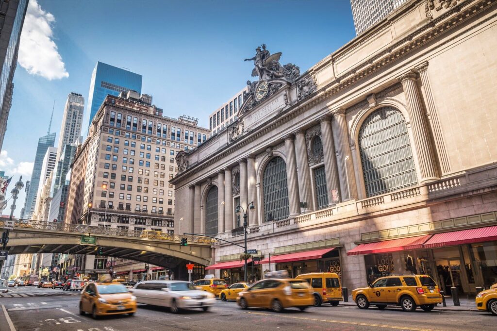 Grand Central Terminal’s façade and Park Avenue Viaduct, with yellow taxis passing below
