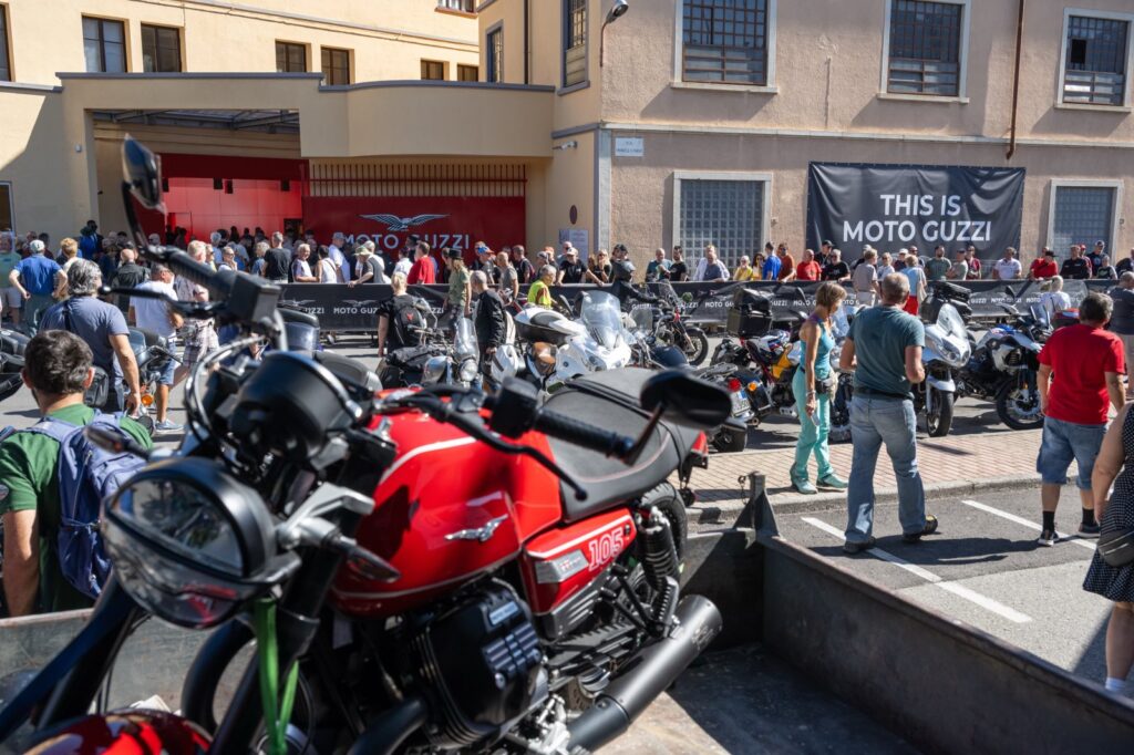 Moto Guzzi motorcycles and visitors outside the factory in Mandello del Lario