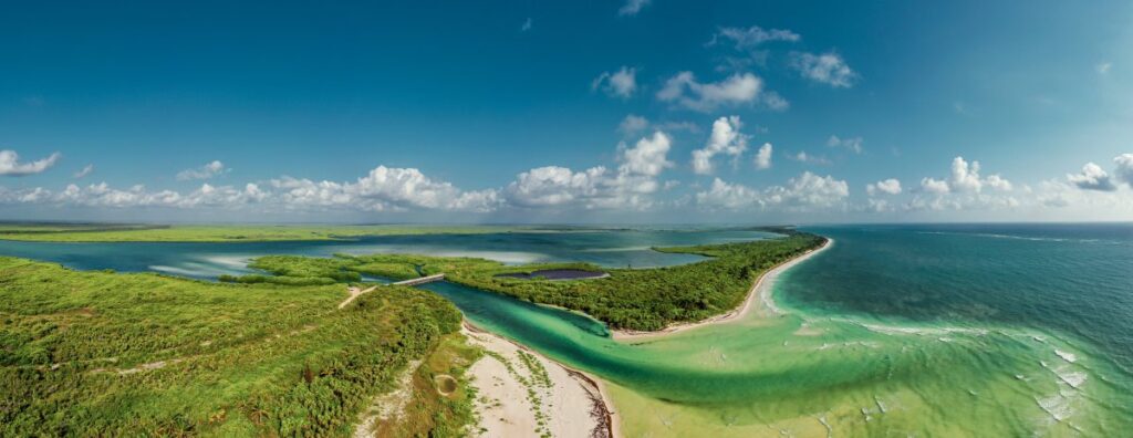 Aerial view of turquoise waterways, mangroves and sandy shores in Sian Ka’an Biosphere Reserve, Mexico.